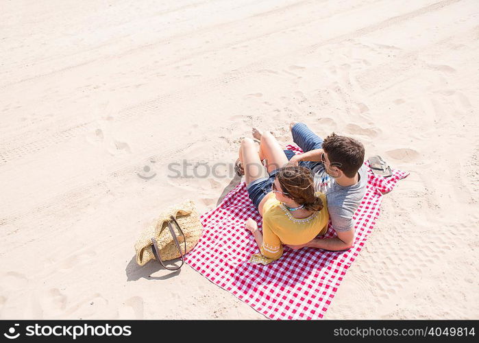 Couple lying on picnic blanket on beach, Coney island, Brooklyn, New York, USA