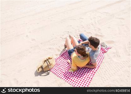 Couple lying on picnic blanket on beach, Coney island, Brooklyn, New York, USA