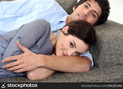 Couple lying on sofa