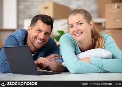 couple lying on the floor of their new apartment