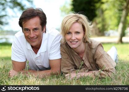 Couple lying on the grass together