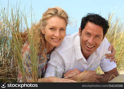 Couple lying on the sand.