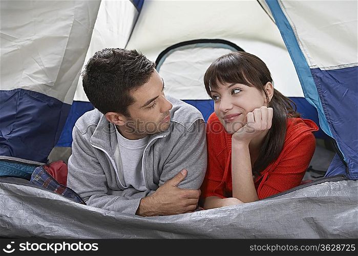 Couple lying side by side in tent