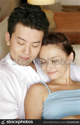 Couple lying together on sofa