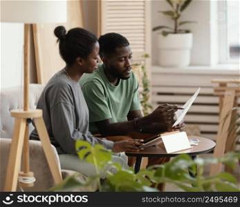 couple making plan using tablet redecorate house