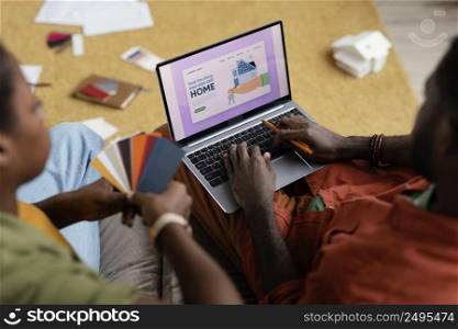 couple making plans renovate house using color palette laptop