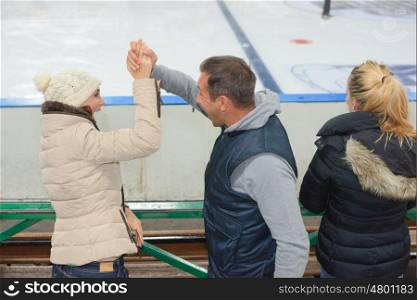 Couple making victory gesture watching their sports team