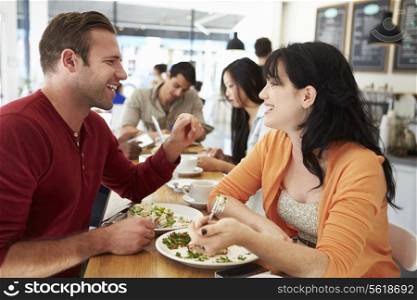 Couple Meeting For Lunch In Busy Cafe