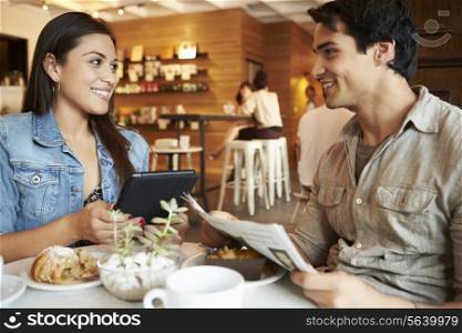 Couple Meeting In Busy Cafe Restaurant