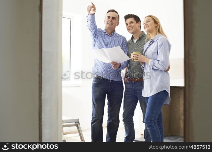 Couple Meeting With Architect Or Builder In Rennovated Property