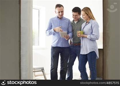 Couple Meeting With Architect Or Builder In Rennovated Property