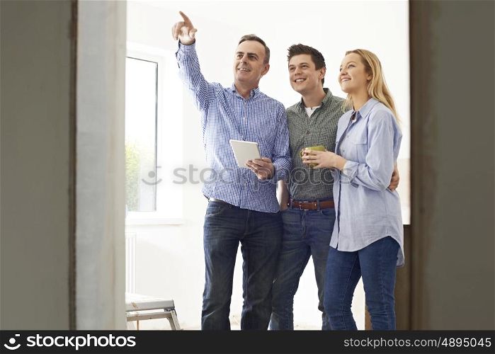 Couple Meeting With Architect Or Builder In Rennovated Property