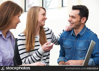 Couple Meeting With Financial Advisor In Office