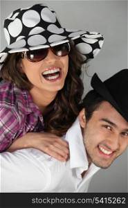 Couple messing around in hats