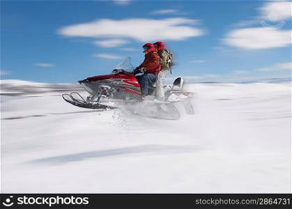 Couple Mid-air on Snowmobile