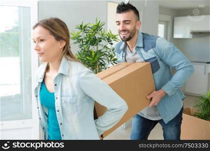 couple moving cardboard boxes