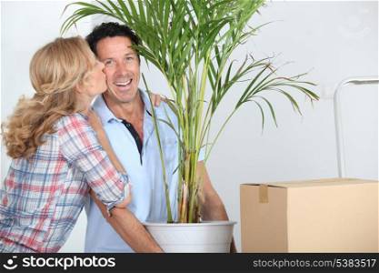 Couple moving in with plant