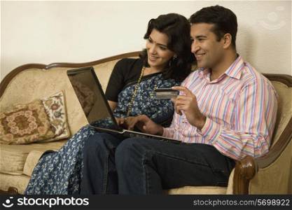 Couple net banking on a laptop