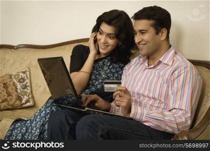 Couple net banking on a laptop