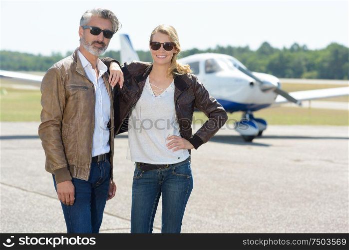couple next to a private jet