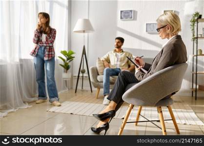 Couple not talking after argument at psychotherapy session. Offended woman turned back to boyfriend. Couple not talking after argument at psychotherapy