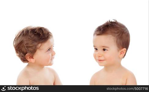 Couple of babies sitting on the floor isolated on a white background