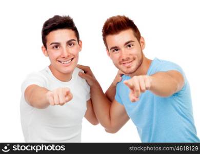 Couple of best friends pointing to the front isolated on a white background
