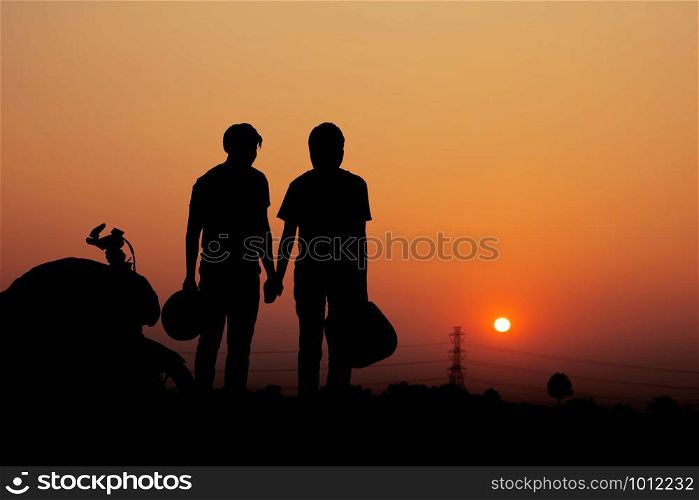 Couple of biker with nature and the sky at sunset.