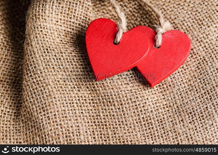 Couple of decorative wooden red hearts for Valentine's day on canvas background