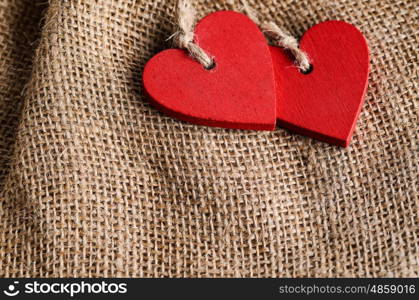 Couple of decorative wooden red hearts for Valentine's day on canvas background