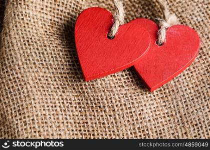 Couple of decorative wooden red hearts for Valentine's day on canvas background
