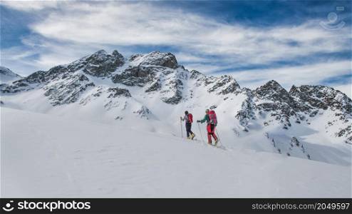 Couple of friends during a ski mountaineering excursion in the Swiss Alps