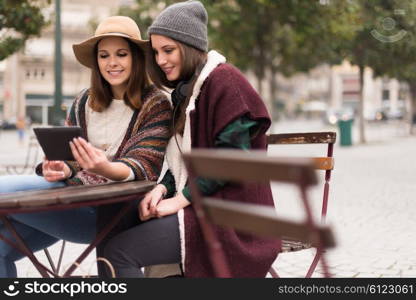 Couple of girls watching funny videos on a digital tablet