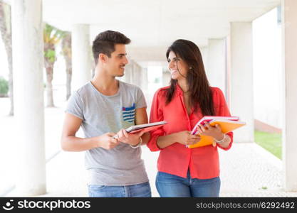 Couple of happy students at the university campus