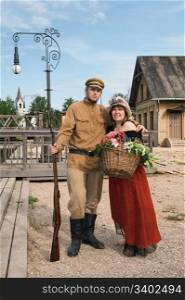 Couple of lady and soldier shown on retro-style picture. Costumes accord the times of World War I. Photo made at cinema city Cinevilla in Latvia.