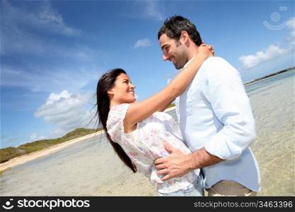 Couple of lovers embracing each other at the beach