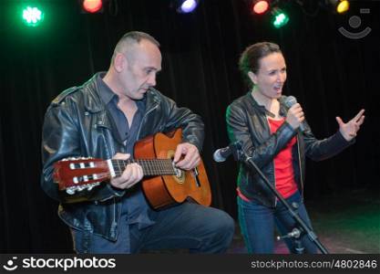 couple of musician playing at a concert together