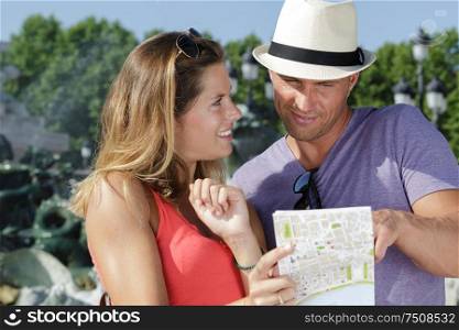 couple of tourist looking at a map