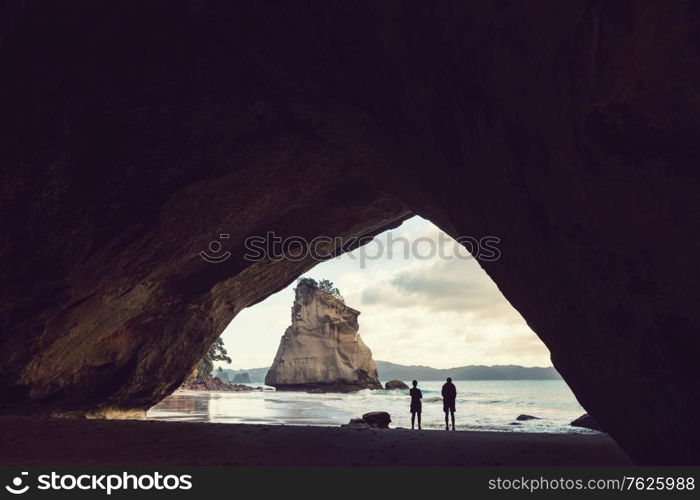 Couple of tourists in the Cathedral Cove, Coromandel Peninsula, New Zealand