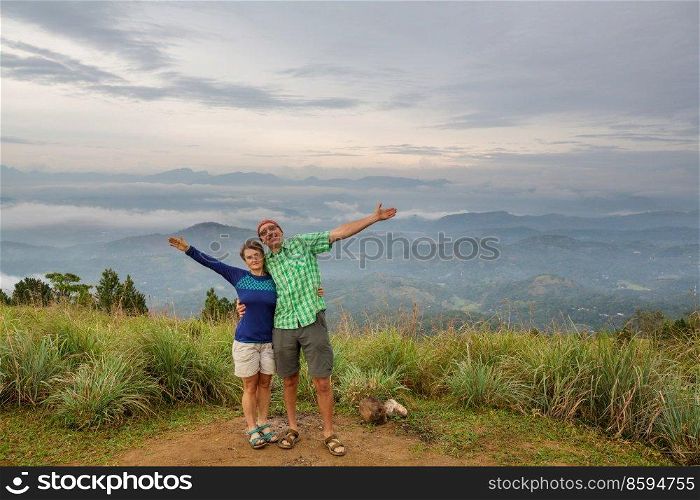 Couple of  tourists  on a vantage point viewing the mountainous landscapes