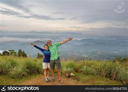 Couple of  tourists  on a vantage point viewing the mountainous landscapes