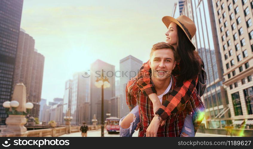 Couple of tourists on excursion between skyscrapers. Summer adventure, young cheerful man and woman are happy together