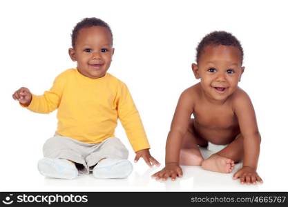 Couple of twins sitting on the floor isolated on a white background