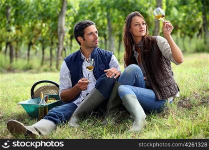 Couple of winegrowers with glasses of wine