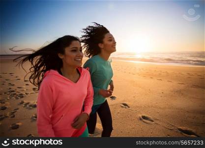 Couple of women running and walking on the beach