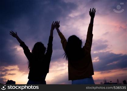 Couple of young asian woman standing open her arms at suset