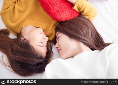 Couple of young asian women on white bed with happiness moment,lesbian couple concept