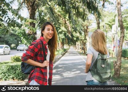 Couple of young Asian women standing along the street enjoying their city lifestyle on weekend waiting for outdoor activity. Young women and their city lifestyle. city lifestyle and outdoor concept.