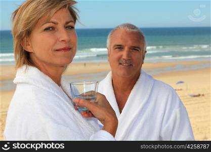 Couple on a beach in bathrobes