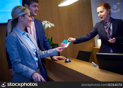 Couple on a business trip doing check-in at the hotel